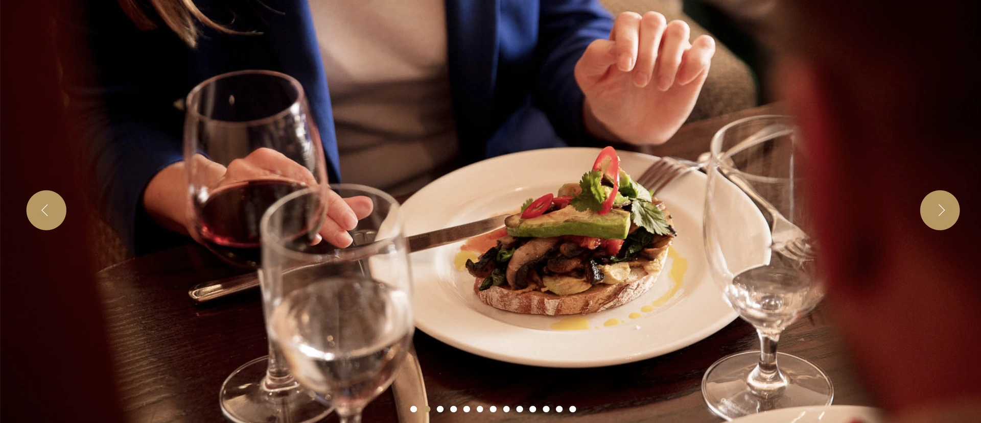 A guest enjoying a plated dish with wine